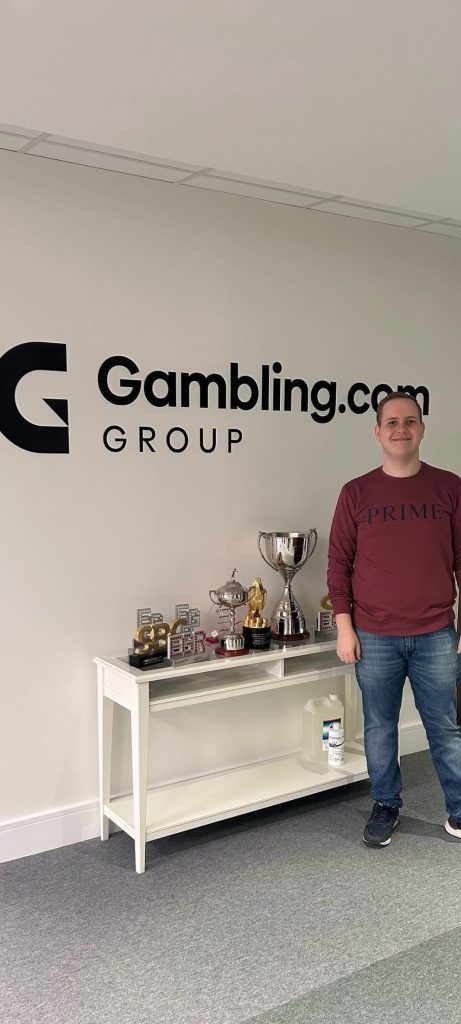 Nikola Stanin standing next to the trophies display section in the Gambling.com offices in Dublin, Ireland, back in October, 2023.